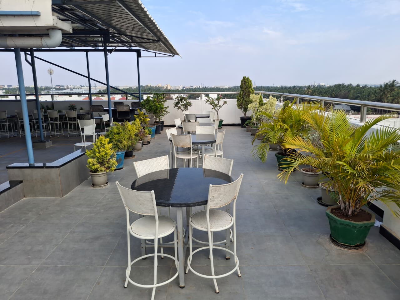 Rooftop terrace garden with seating, plants, and panoramic views