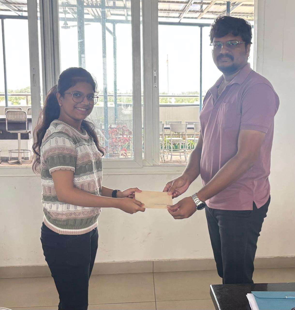 Employee's child being felicitated for academic achievement