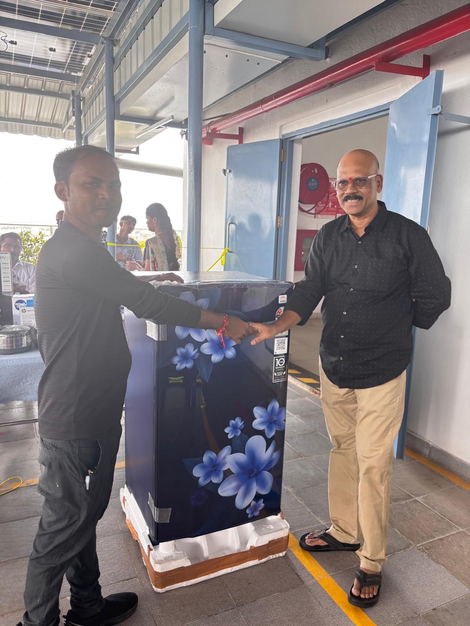 Diwali lucky draw — employee receiving appliance prize